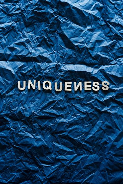 Just a crumbled blue paper with words "Uniqueness" on it in a fancy manner