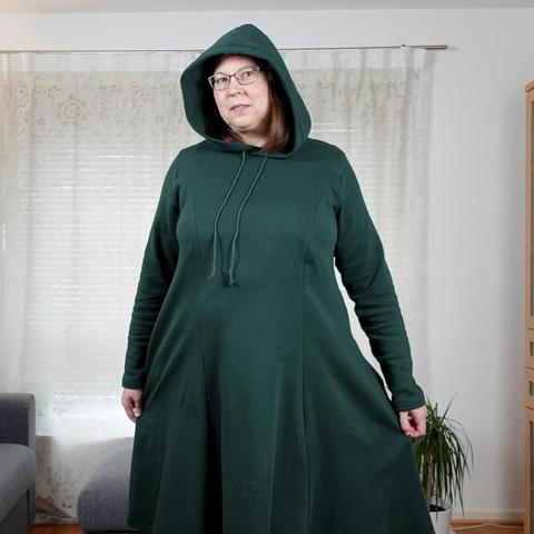 A woman in a long green hoodie dress with princess lines