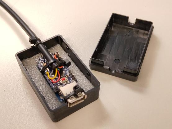 The small case with the Arduino-Nano based X68000 USB mouse adapter built into. Also visible the modifications made to the plastic to accompany the USB port.
