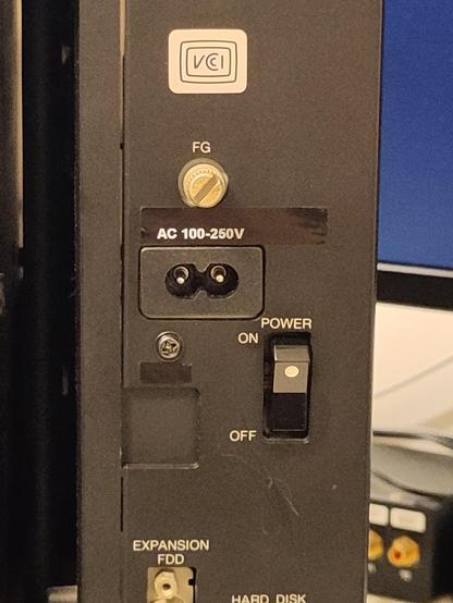 Added a matching white-on-black label on the back machine, to match the modified power supply. The previous power-output for the monitor is now a generic input. The previous power input is blanked off.