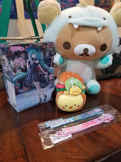 Pic of hatsune miku figure, rilakkuma plush, bird in a bun plush, 2 sanrio lanyard