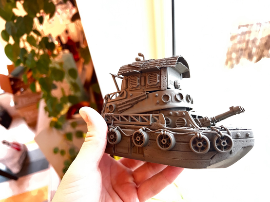 Scale model of a little tug boat. It's painted in a gray primer coat and looks derpy.