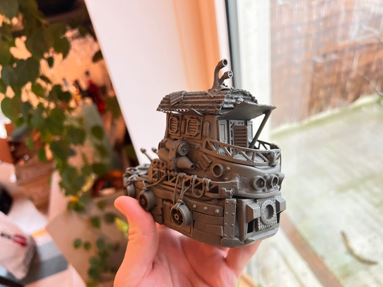 Scale model of a little tug boat. It's painted in a gray primer coat and looks derpy.