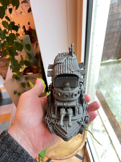 Scale model of a little tug boat. It's painted in a gray primer coat and looks derpy.