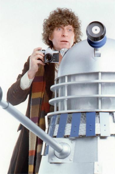 The 4th Doctor, Tom Baker, poses with a Dalek for a photoshoot.

You know, as much as I hate being old, I am so grateful that my personal time-stream lined up with this man's, and that my younger incarnation got to watch him in Doctor Who on Saturday nights back in the day.

Of course, today, you can stream those same episodes, mega-restored in ultra-high-def whatever, but honestly, I'd rather be watching at my Nan's house... sitting impatiently through the Grandstand teleprinter and Basil Brush's interminable jokes as I waited to accompany the greatest Time Lord of them all on another thrilling adventure.

Oh, and those delicious cliff-hangers endings... You knew it was coming, but when the theme-tune would come crashing in I'd feel it - physically - like I was being hit in the chest by a great tidal wave. I'd surf that wave through the weekend, only to be left washed up at school on a Monday morning and desperate for Saturday to come round again (and, boy, didn't the days just seem to crawl back then - I wish they did now).

Tom Baker's Doctor Who wasn't just a television programme, it was the wallpaper that covered the bedroom of my existence... or something... no, forget that, I'm getting a bit carried away now, sorry. However, it really was something truly special, and if you didn't get to experience Doctor Who at its peak then I feel sorry for you.

Happy Birthday, Mr Baker. Thanks for the memories.