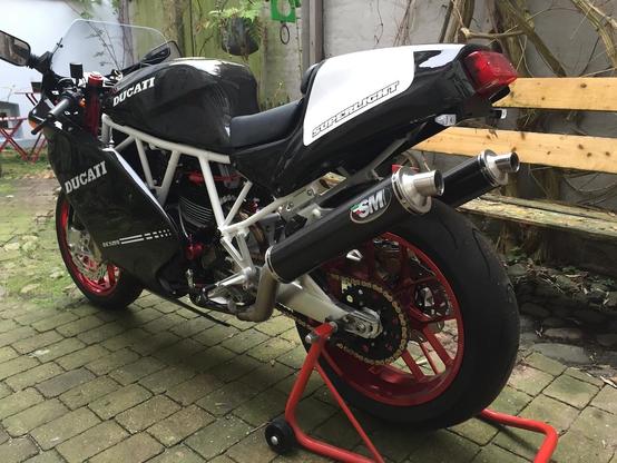 Ducati 750 SS, Black with a white ladder frame and red wheels.