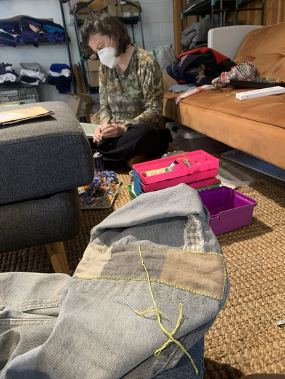 Mending a pair of jeans with linen patches