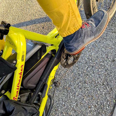 A photo of my right foot on the pedal of a 

yellow Tern HSD cargo bike with its name, Sunstreaker, in red on the seat stay

I'm wearing

navy blue boots under a yellow pantleg