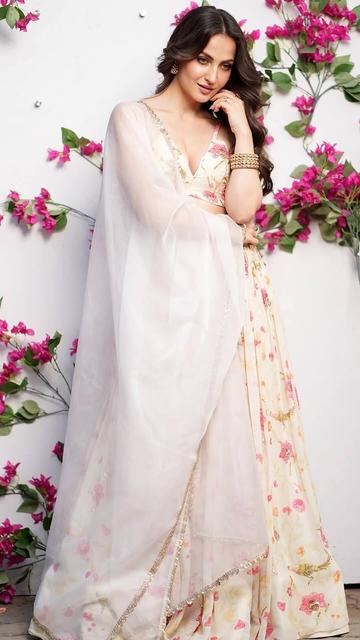 In a stunning display of fashion, Elli AvrRam dons a floral lehenga from Paulmi & Harsh. The ensemble is adorned with intricate floral patterns and a mix of vibrant colours, reflecting the beauty of nature. Paired with minimalistic jewellery and a natural makeup look, Elli's attire showcases the designer's skill in blending traditional motifs with modern aesthetics.