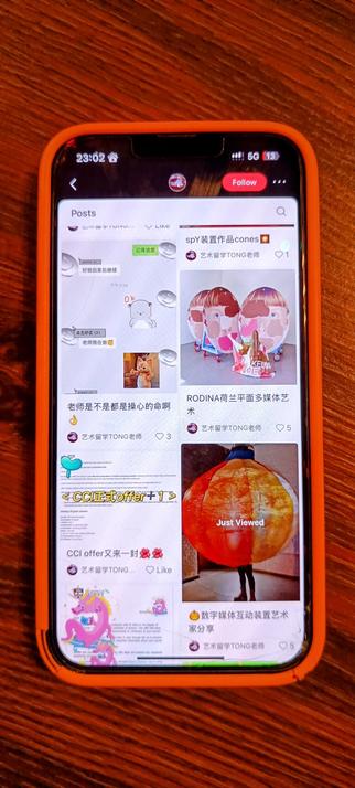 Photo of a phone displaying RedNote app feed