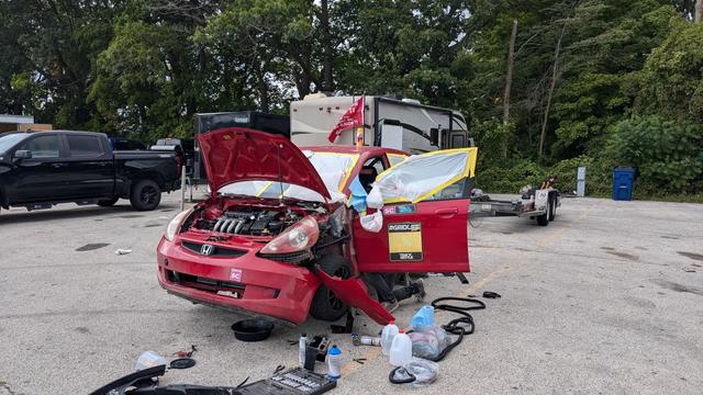 the epitome of a Lemons racing car

on jack stands, all wheels off, fender and bumper partially disassembled, just in shambles 