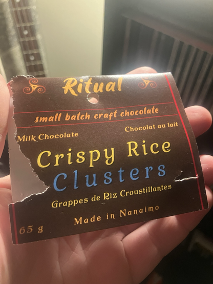 Hand holding the label of a package of chocolate crispy rice clusters