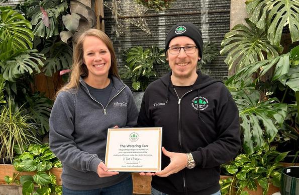 Thomas of Village of Hope Niagara presented Sue at The Watering Can Flower Market with a recognition plaque for their commitment to Being The Difference in our community