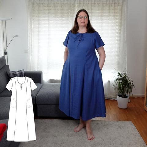 Full body shot af a woman in a long light blue dress with a lacing detail at the neckline. In the bottom left corner, a linedrawing of the dresspattern. 