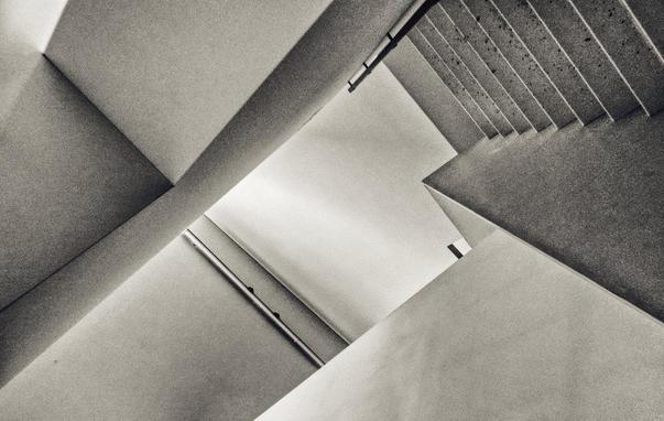 slightly disorientating monochrome photo of a stairwell