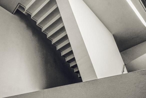 slightly disorientating monochrome photo of a stairwell