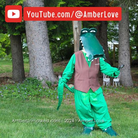 Amber dressed in alligator costume wearing a brown vest and holding a magnifying glass for proper crime solving. YouTube red arrow logo and channel YouTube.com/@AmberLove