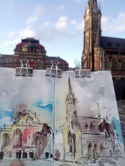 An ink and watercolour sketch of an opera house and a church together with the original scenery.