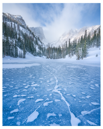 Rocky Mountain National Park frozen lake with mountains 