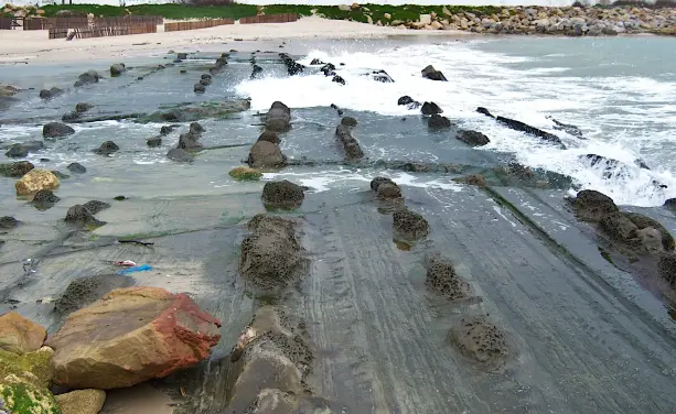 Cellular weathering in beach rocks. (Overview) Playa Chica, Tarifa, Spain.