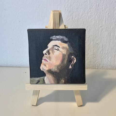 7 by 7 cm portrait on a little easel. Profile facing left squinting at the bright sunshine, against a dark background
