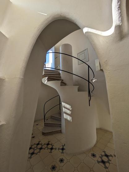 White plaster spiral staircase leading upwards