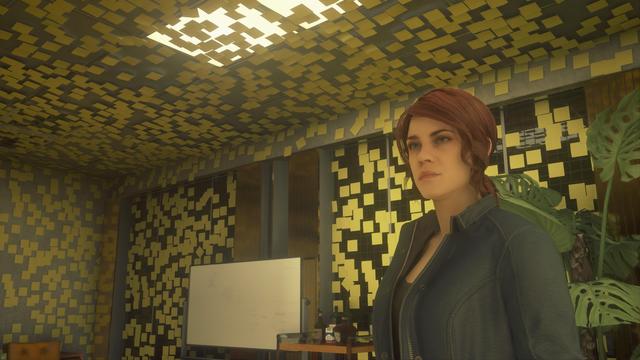 A screenshot of Jesse Faden in a room covered from floor to ceiling with mysterious Post-It notes. 