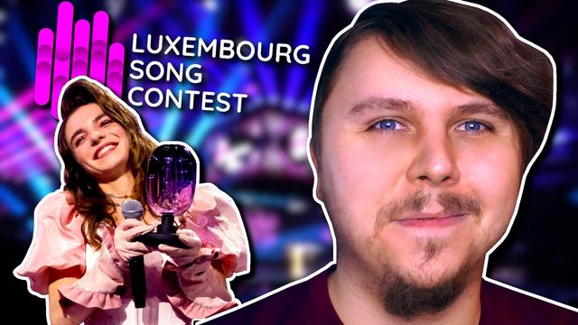 The video thumbnail. Against a blurred stage background, Laura Thorn is left, holding a microphone in one hand and a glass trophy in another, posing for a photo. I am right, wearing a red t-shirt and smiling towards the camera. Behind Laura's head is the 'Luxembourg Song Contest' logo.