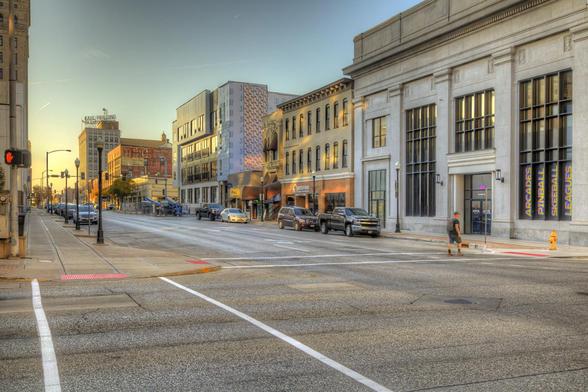 An urban street scene features historic buildings with large windows, creating a sense of depth and space.