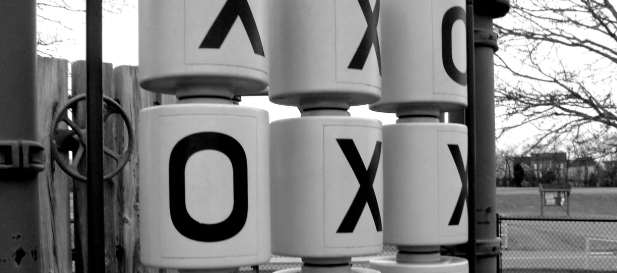 A picture of one of those playground tic-tac-toe games, illustrating the point of a zero-sum game.