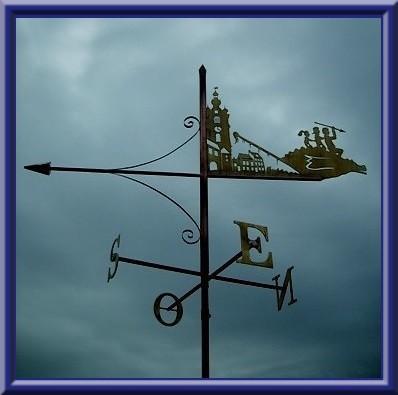 ▪️ Girouette ‘Doudou de Mons’ (beffroi, maisons typiques, dragon, enfants)
▪️ Weathervane ‘Doudou of Mons’ (belfry, typical houses, dragon, children) 
▪️ Windwijzer ‘Doudou van Mons’ (belfort, typische huizen, draak, kinderen)
▪️ Wetterfahne ‘Doudou von Mons’ (Belfried, typische Häuser, Drache, Kinder)
▪️ Banderuola ‘Doudou di Mons’ ▪️ (torre civica, case enveloppe tipiche, drago, bambini) 
🔹 
Oeuvre: Thierry SORET, artisan d’art, girouettier 
