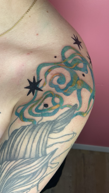 Freehand abstract tattoo in blue and yellow