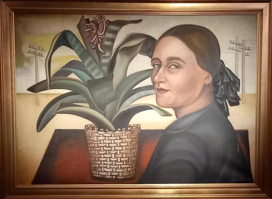 Cet autoportrait de Nadia Léger est le premier tableau présenté dans l'exposition qui lui est consacrée au musée Maillol. Elle est de profil, devant une plante d'intérieur. En arrière plan, des poteaux électriques.