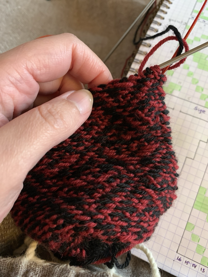 Inside-out red and black stranded knitting work-in-progress. 