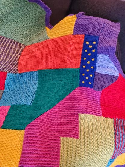 Close-up of stitches, shapes and colours on a wacky crocheted afghan