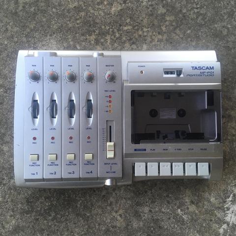 A Tascam MF-P01 cassette multitrack recorder as seen from above, resting on a stone surface.