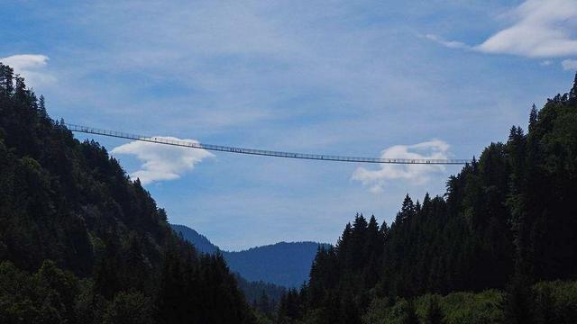 Long rope bridge across valley.
