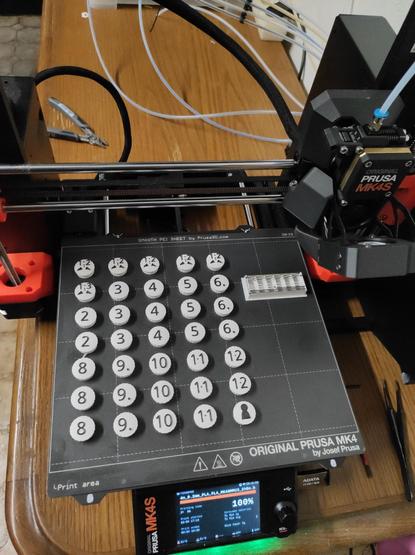 Game pieces with black on white numbers multicolor 3d print still on build plate