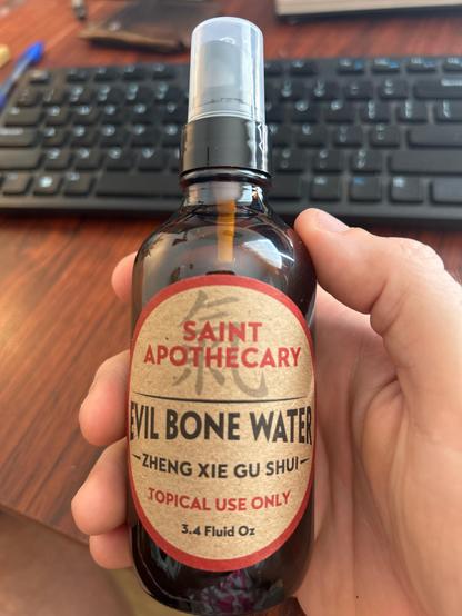 A spray bottle of Evil Bone Water made by Saint Apothecary 