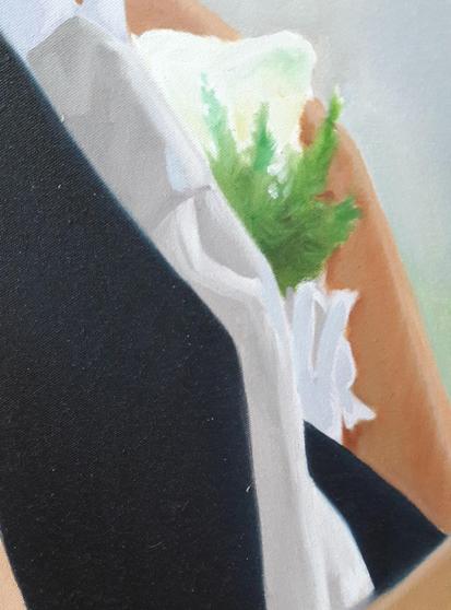 a close-up of the groom's chest, he is wearing a corsage 