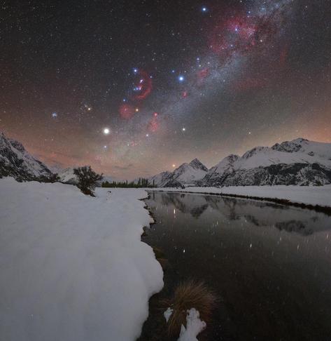 Orion and the summer Milky Way (winter Milky Way for the northern hemisphere), seen above a late season snowfall in the mountains of New Zealand