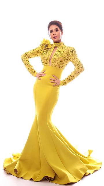 Urmila Matondkar proves once again why she is a timeless beauty in this stunning designer yellow gown. The fitted bodice, dramatic train and intricate detailing make it a show-stopping look. Paired with sultry smokey eyes and a classic updo, this is red carpet glamour at its finest.