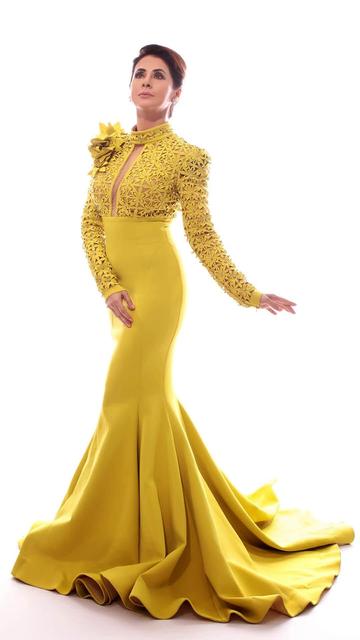 A fashion moment to remember Urmila Matondkar dazzles in a sunshine yellow gown featuring floral embellishments and a sculpted silhouette. Styled with elegant diamond accessories and flawless makeup, this look is every bit as regal as it gets.