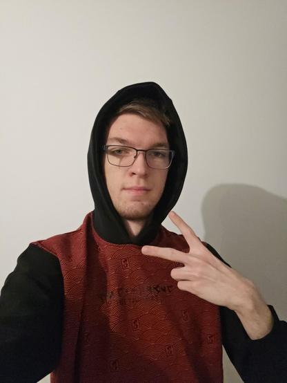 Maingron wearing red Friendly Fire hoodie