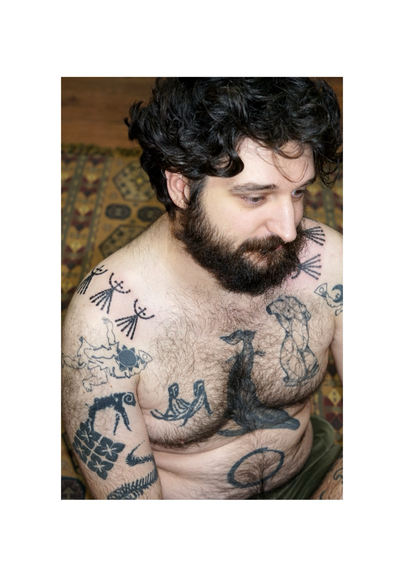 Tattooed patterns on the shoulders done in Lyon