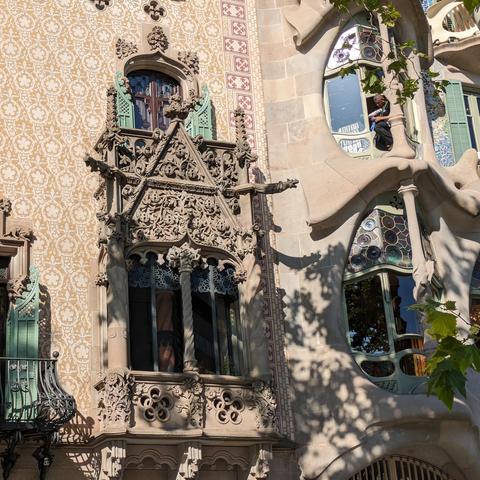 Moroccan inspired tile work and fancy balcony on the building next to casa batllo
