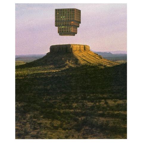 building hovering over a mountain in monument valley at he end of the day with a low sun from outside the frame