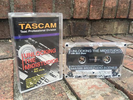 A tutorial cassette entitled “Tascam: Unlocking The Midistudios” rests on some brick steps.