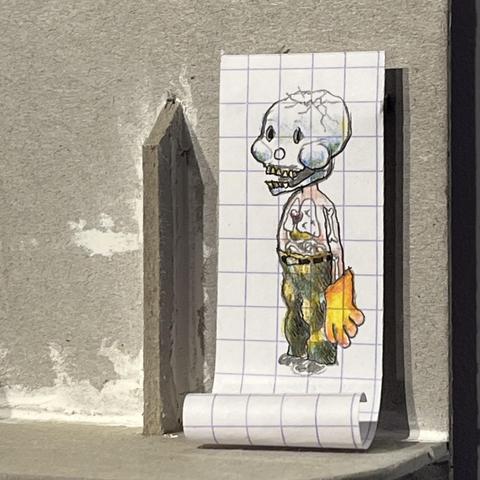 This man wears a mask of a broken skull, but the organs are visible through the skin. He is drawn on a squared paper, gently rolled.