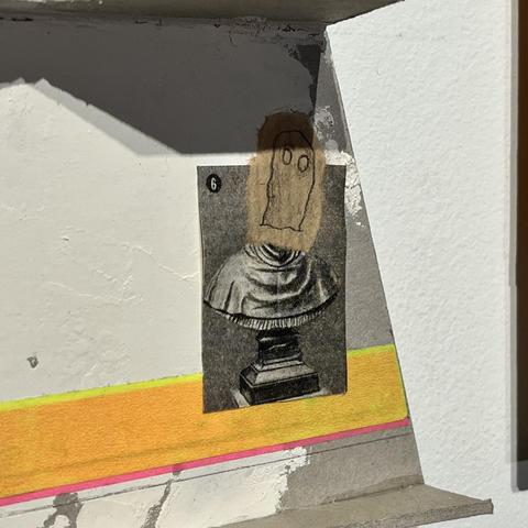 And a photograph of a bust with a mask sticked to it, and some brightly colored tape.